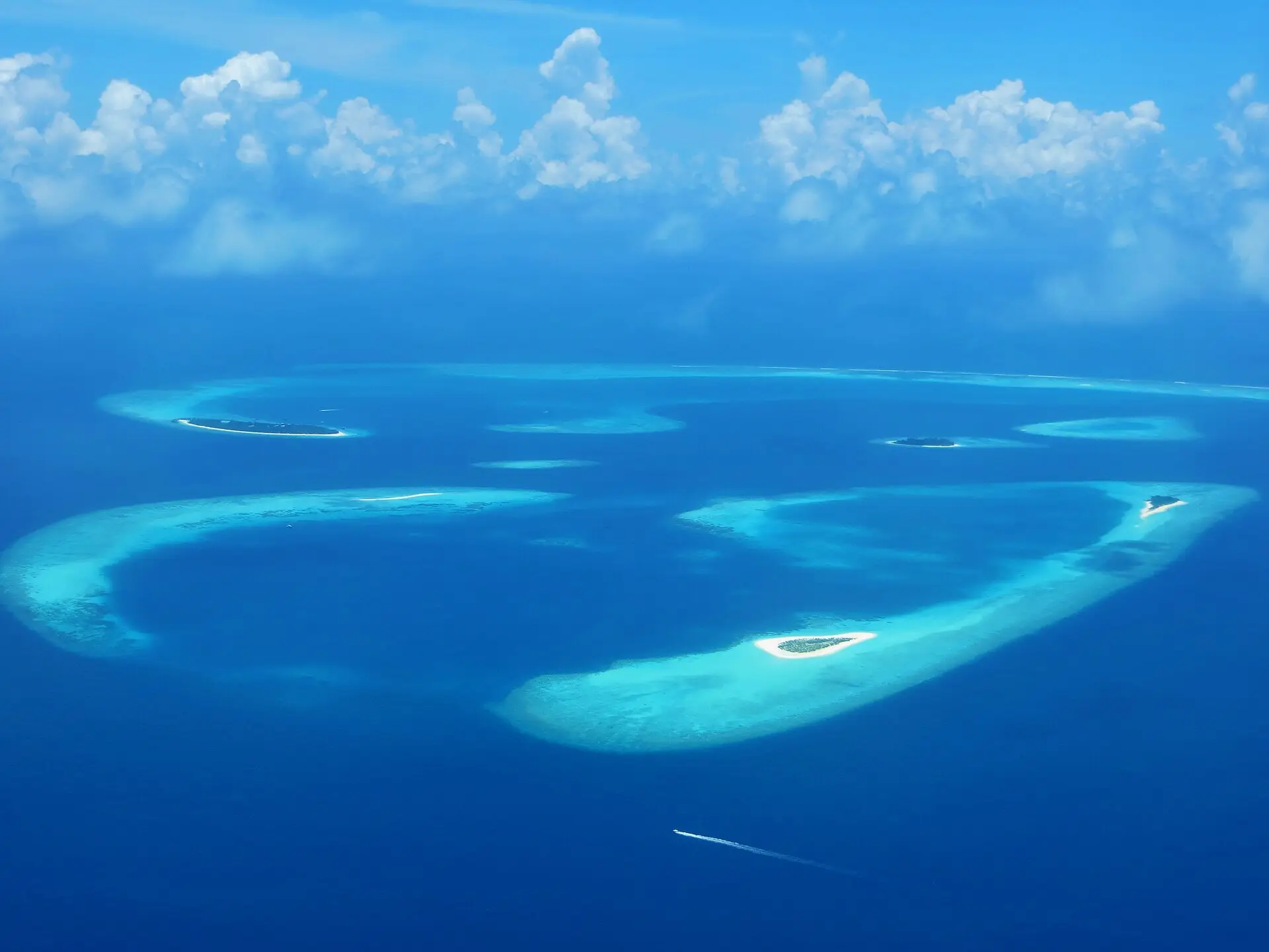 Aerial view of ring-shaped reefs and small islands, including Veyofushi, in Baa Atoll