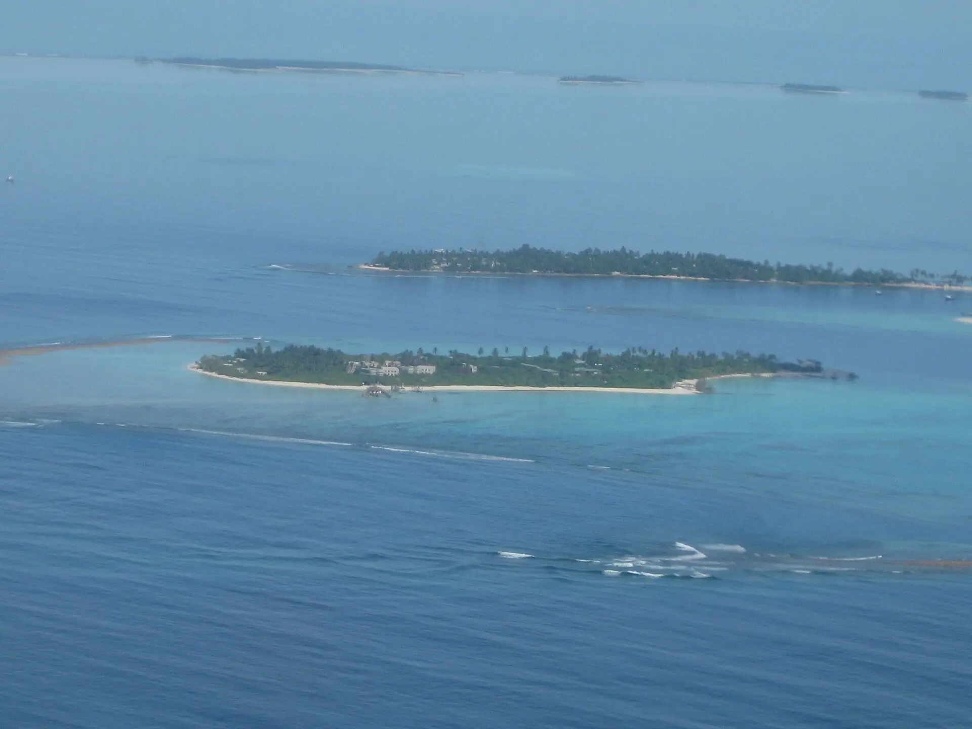 Aerial view of two low islands, including Olhuveli, in the lagoon of Laamu Atoll