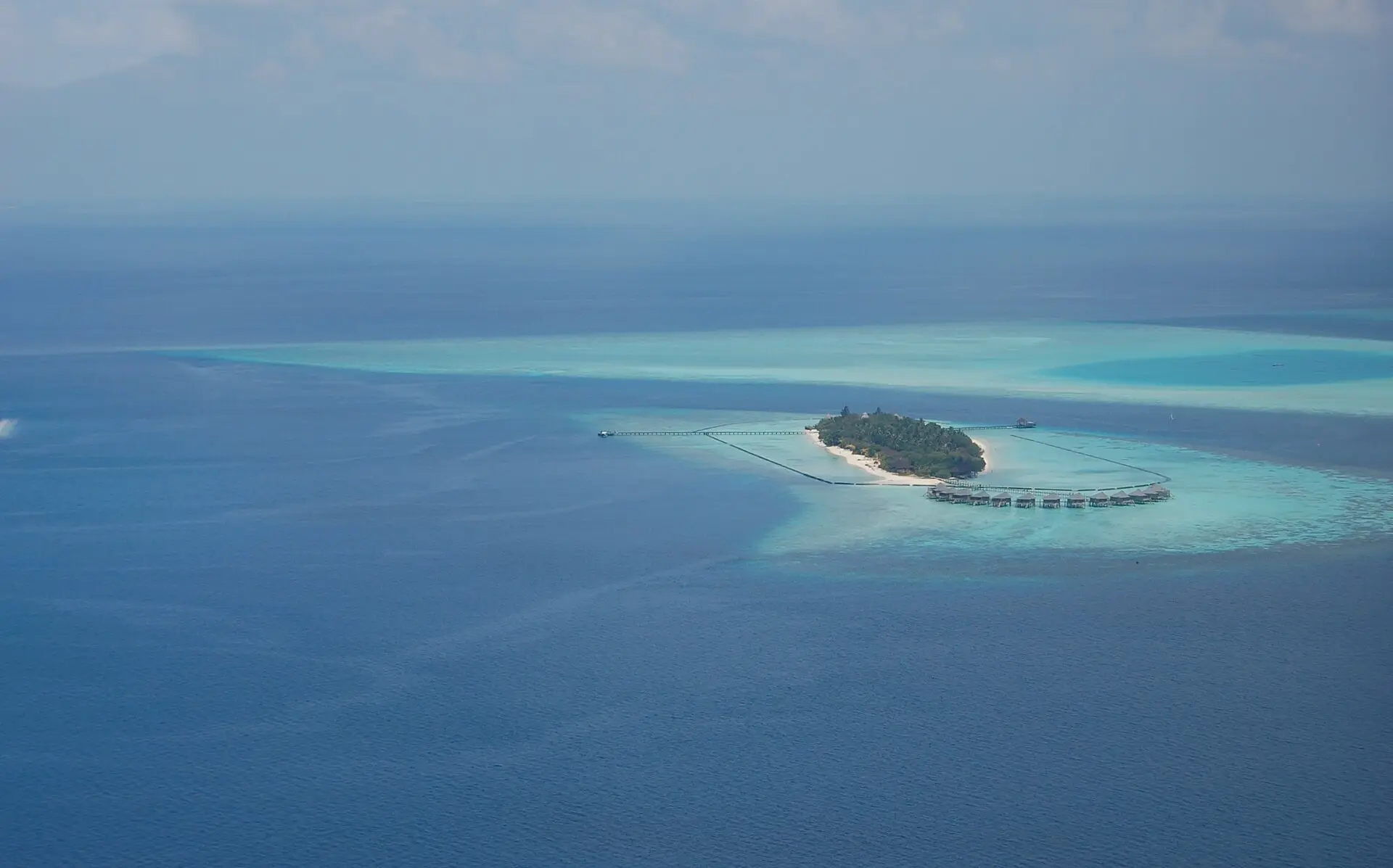 Aerial view of the small resort island of Komandoo on its reef in Lhaviyani Atoll